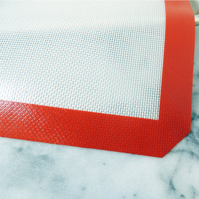 Texture silicone baking mat with red border, half sheet size